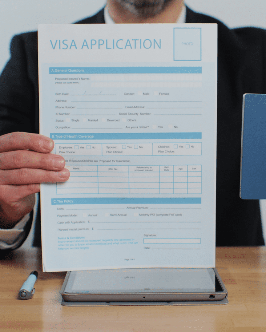 A person holding up an application form.