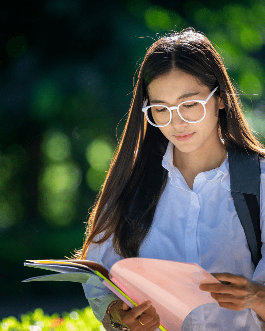 A woman reading a book in the sun.