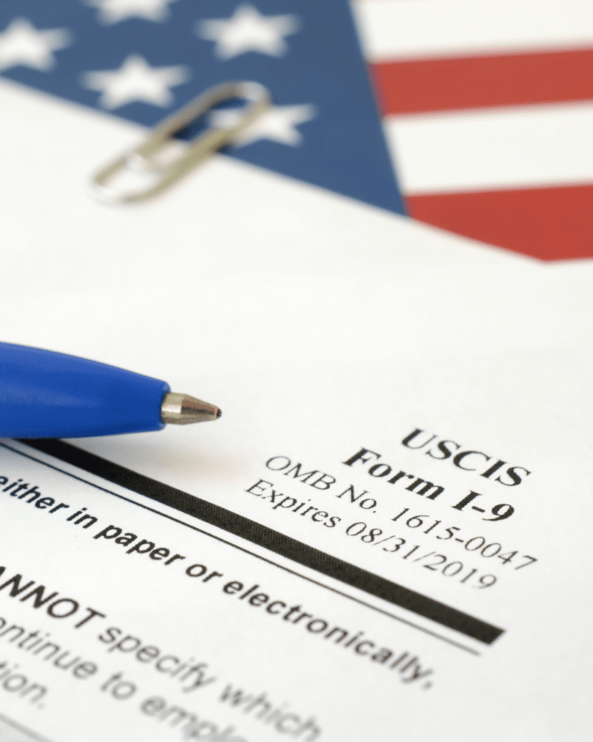 A pen and paper on top of an uscis form.