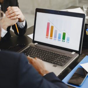 A person sitting at a table with a laptop