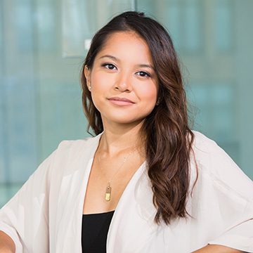 A woman with long hair wearing a white jacket.